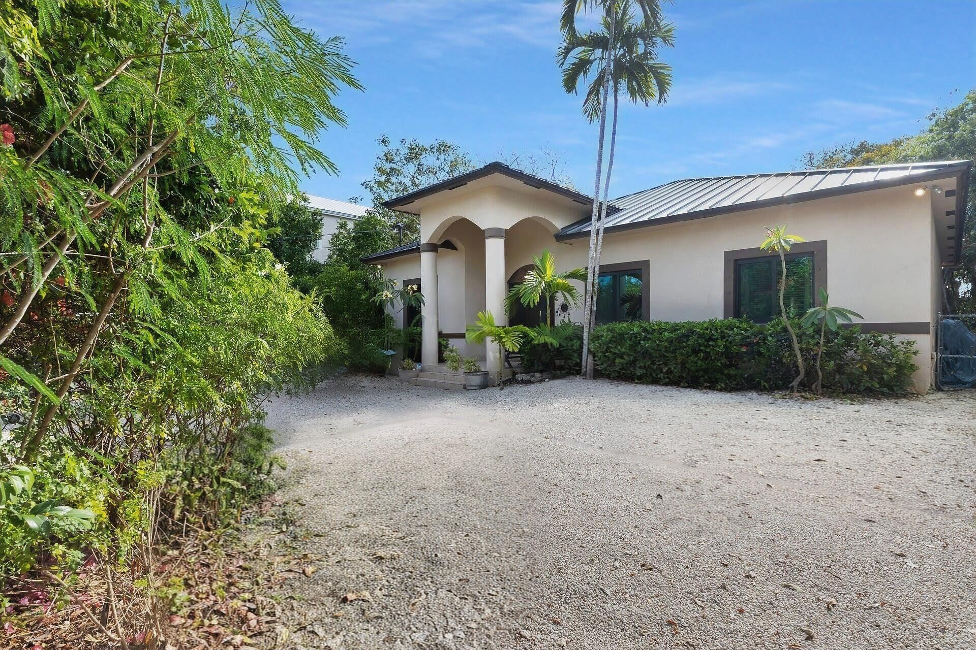 6 Fishermans Trail Key Largo, FL 33037 - Photo 33 of 50 a view of a house with a yard and potted plants