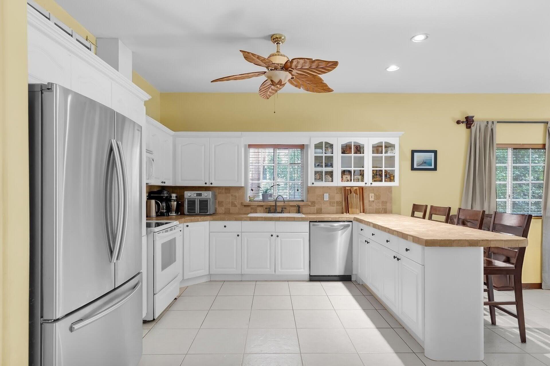 6 Fishermans Trail Key Largo, FL 33037 - Photo 8 of 50 a kitchen with a sink refrigerator and cabinets