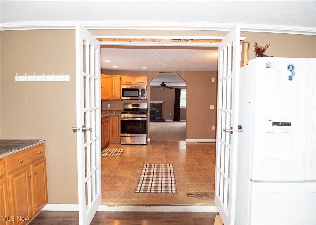 1549 Ridge Road Northeast New Philadelphia, OH 44663 - Photo 22 of 46 French doors open to dining room area