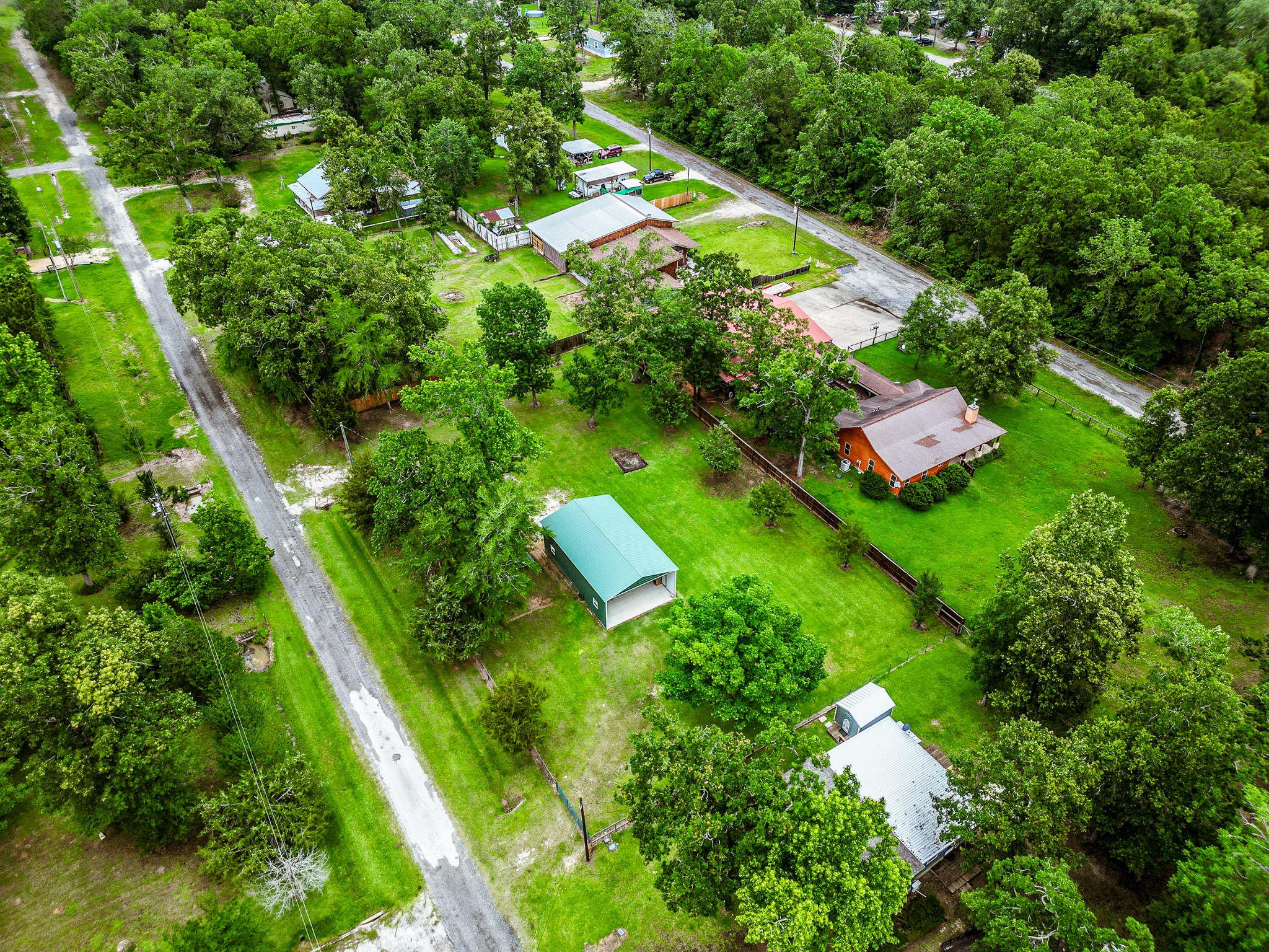 140 6th Street Trinity, TX 75862 - Photo 7 of 13 an aerial view of residential houses with outdoor space and trees all around