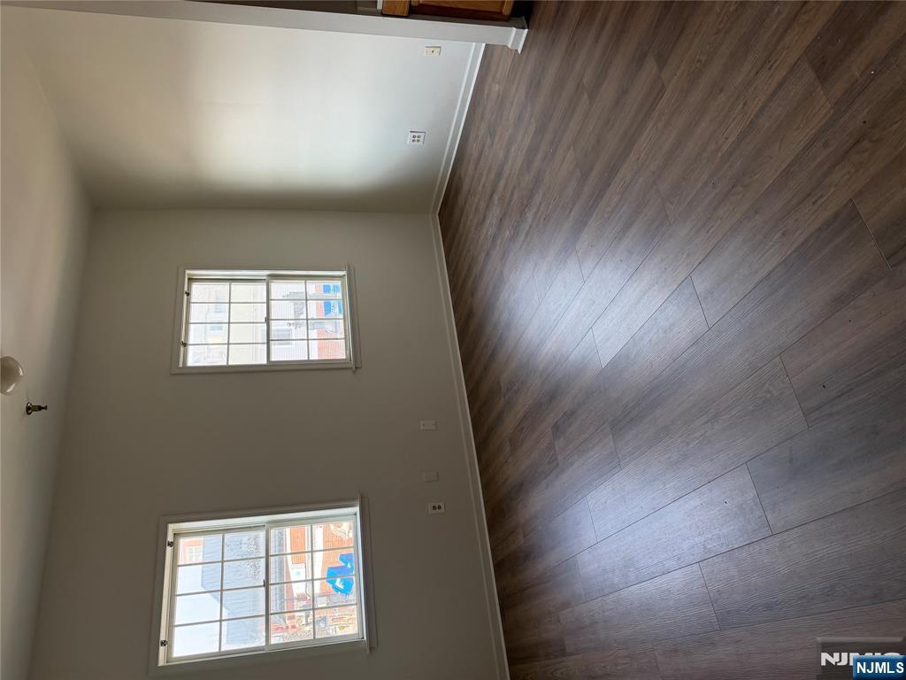 250 Park Avenue, Unit 1 East Rutherford, NJ 07073 - Photo 5 of 8 an empty room with wooden floor and windows