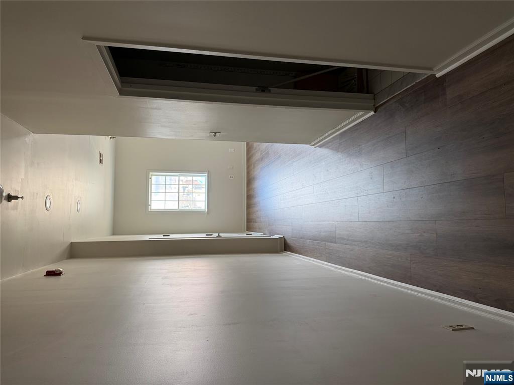 250 Park Avenue, Unit 1 East Rutherford, NJ 07073 - Photo 6 of 8 an empty room with wooden floor and windows