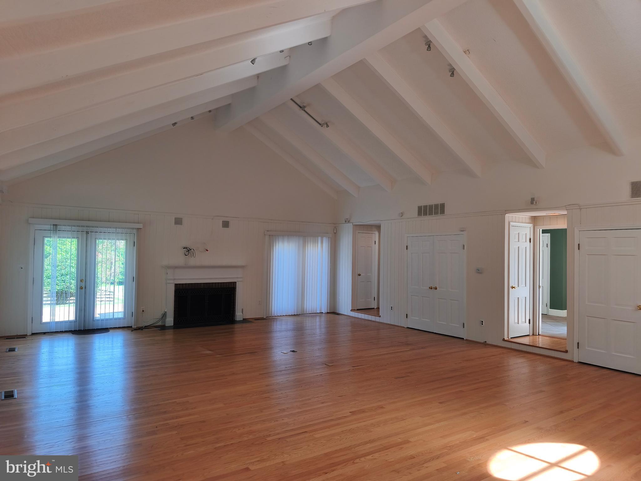 901 Walker Road Great Falls, VA 22066 - Photo 14 of 57 a view of empty room with wooden floor and fireplace
