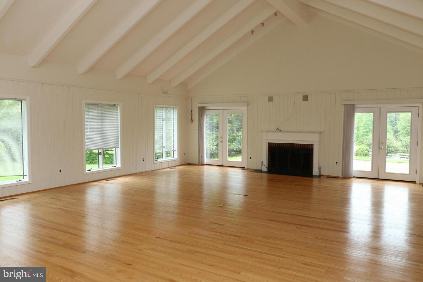 901 Walker Road Great Falls, VA 22066 - Photo 15 of 57 a view of empty room with wooden floor and fireplace