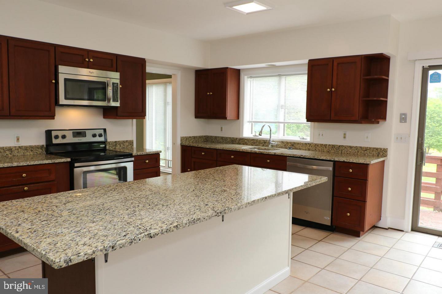 901 Walker Road Great Falls, VA 22066 - Photo 19 of 57 a kitchen with stainless steel appliances granite countertop a sink stove and refrigerator