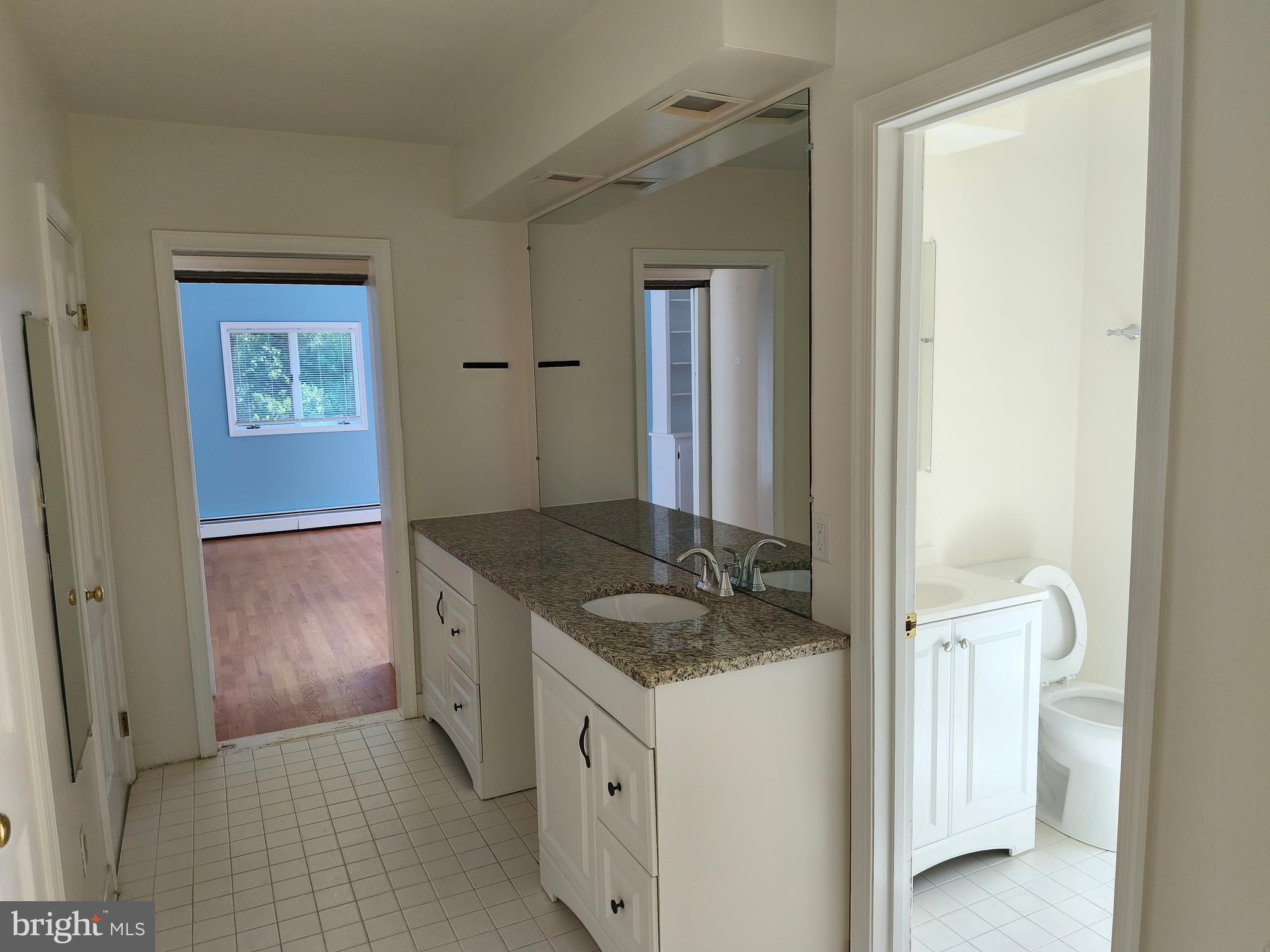 901 Walker Road Great Falls, VA 22066 - Photo 29 of 57 a bathroom with a granite countertop sink and a mirror