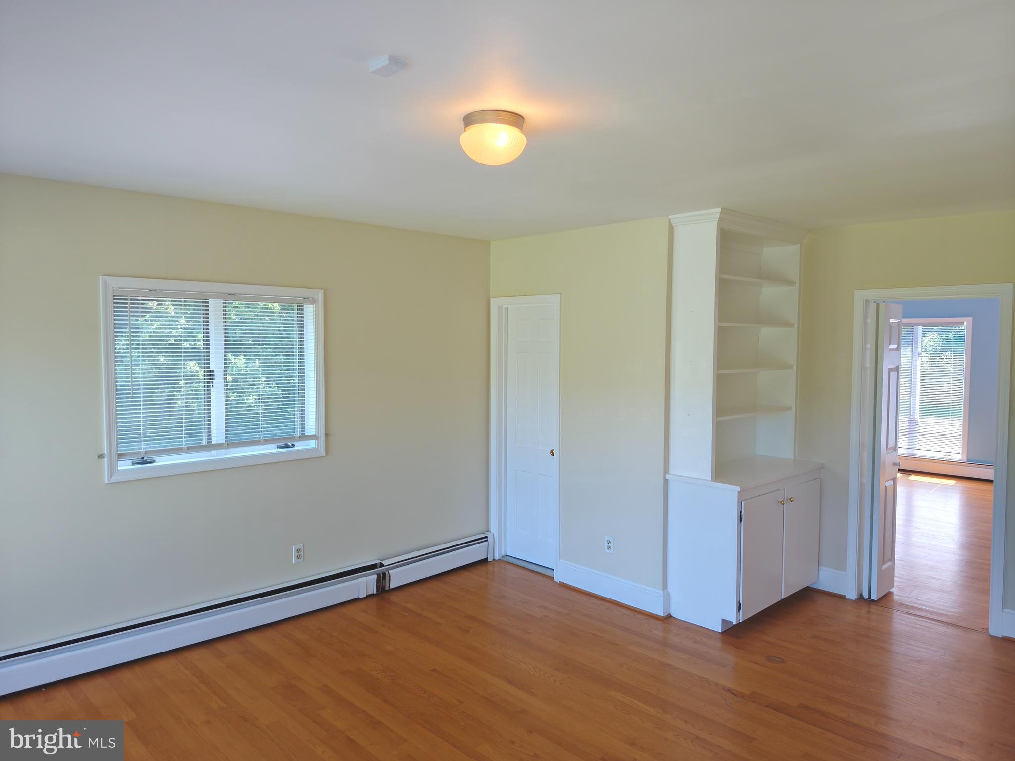 901 Walker Road Great Falls, VA 22066 - Photo 37 of 57 an empty room with wooden floor and windows
