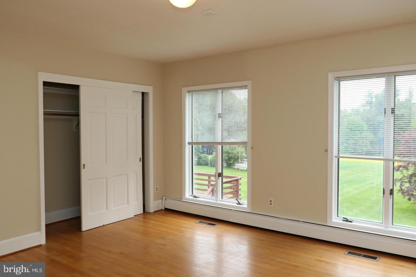 901 Walker Road Great Falls, VA 22066 - Photo 38 of 57 an empty room with wooden floor and windows