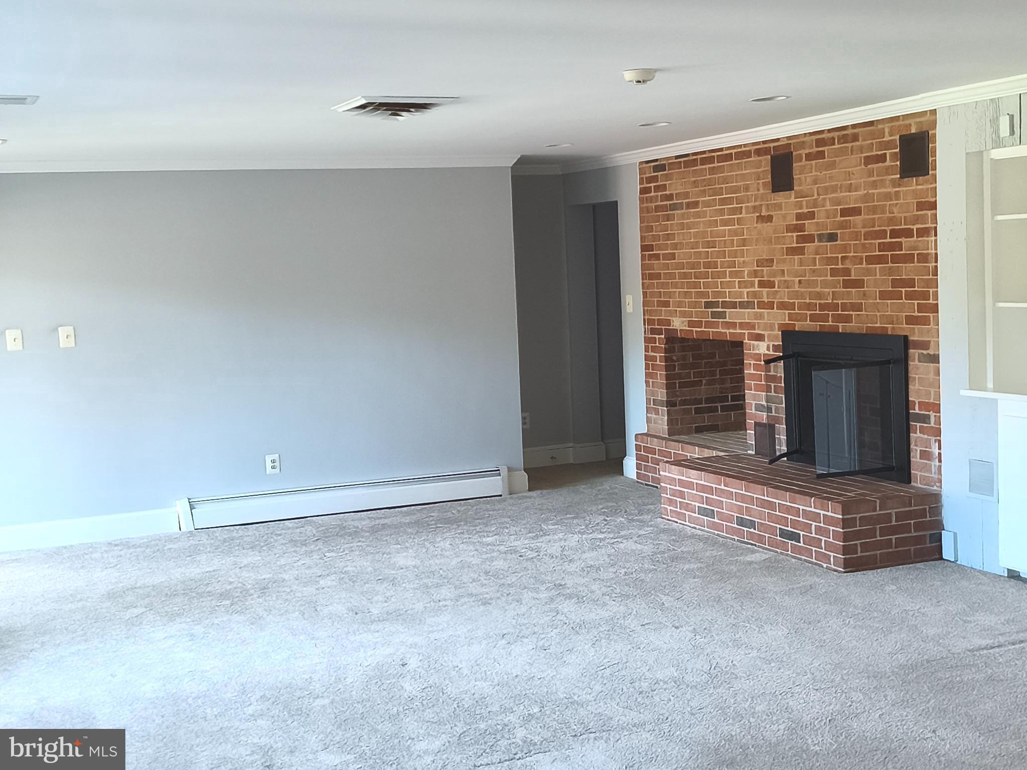 901 Walker Road Great Falls, VA 22066 - Photo 46 of 57 an empty room with fireplace and windows