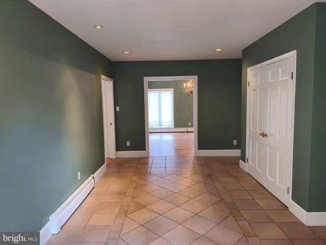 a view of a hallway with wooden shelves