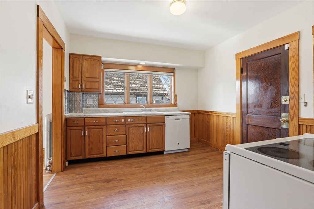 67 Lake Street, Unit 2 Arlington, MA 02474 - Photo 2 of 16 a kitchen with a stove a sink and a refrigerator
