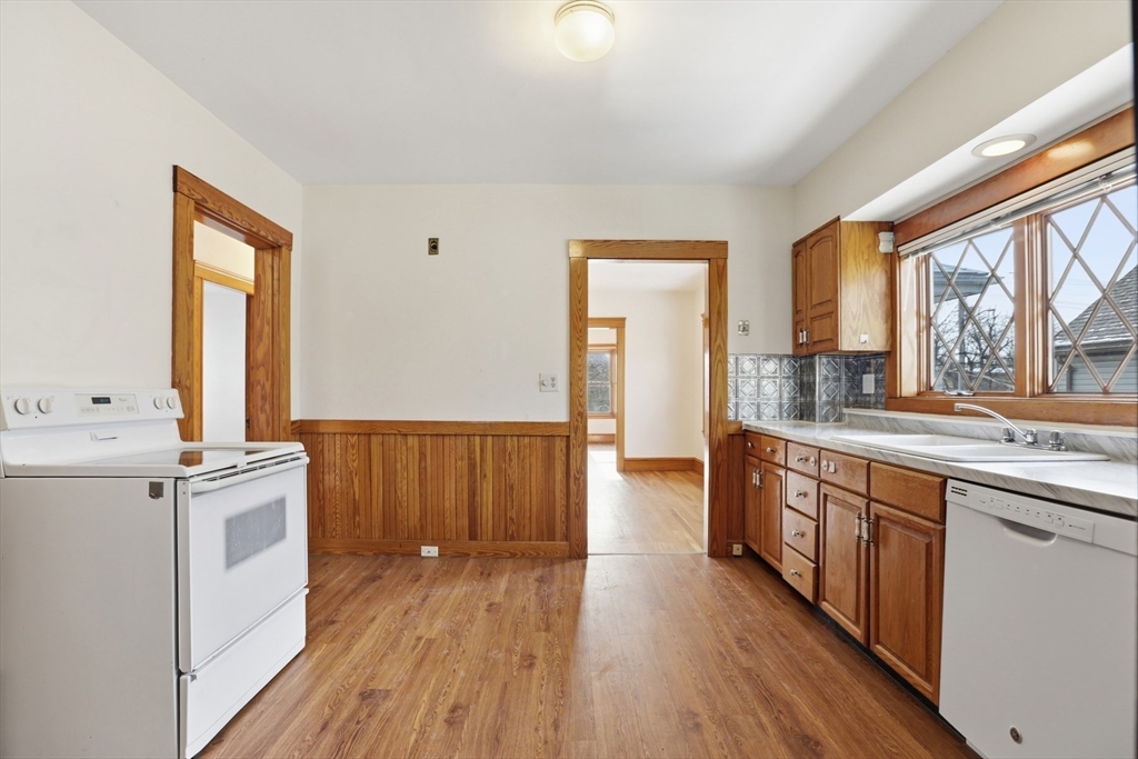 67 Lake Street, Unit 2 Arlington, MA 02474 - Photo 4 of 16 a view of a kitchen with wooden floor and electronic appliances
