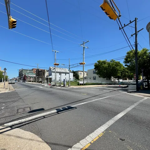 a view of a city street with a car parked on the road