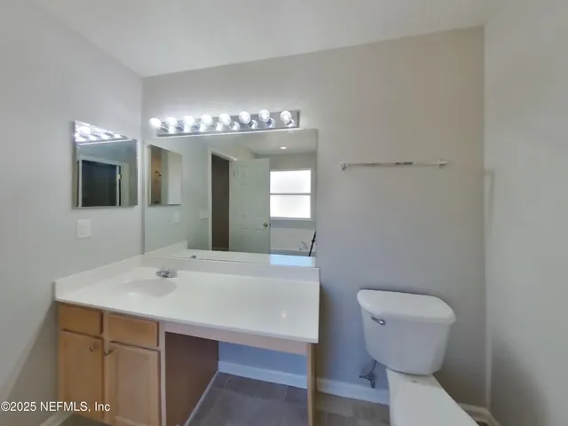 a bathroom with a sink and mirror