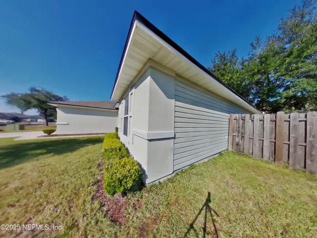 a view of a backyard with large trees