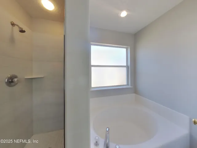 a bathroom with a bathtub and shower
