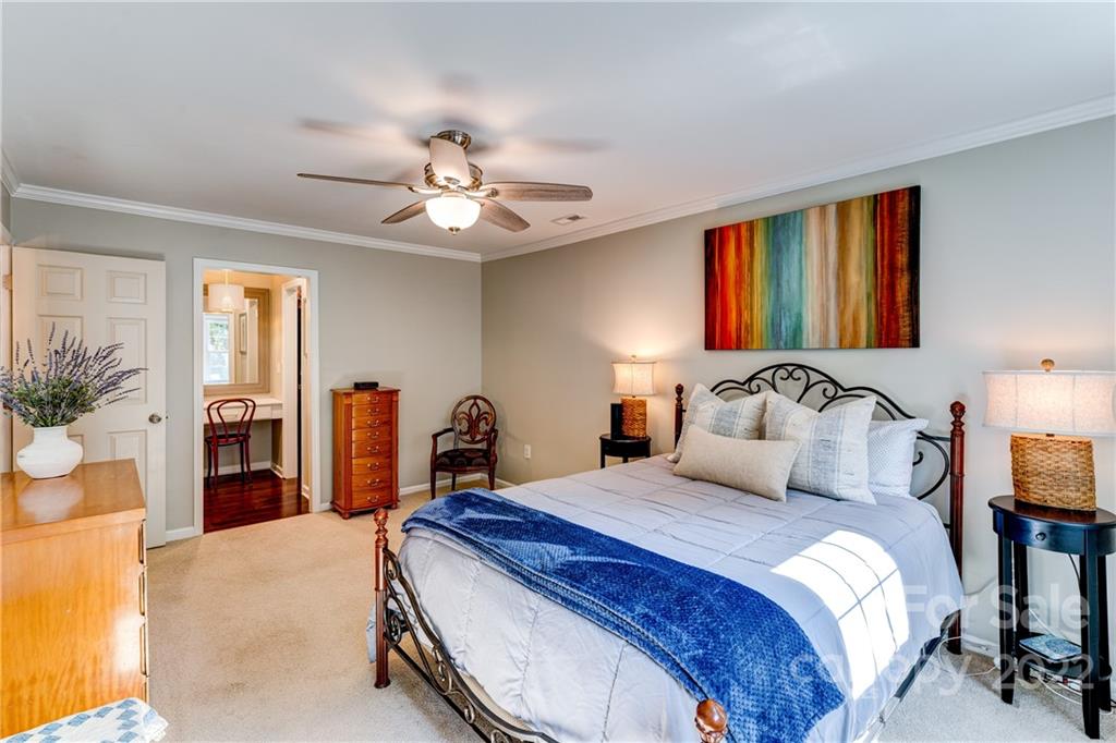 7046 Chelsea Day Lane Tega Cay, SC 29708 - Photo 23 of 36 a bedroom with a bed and ceiling fan