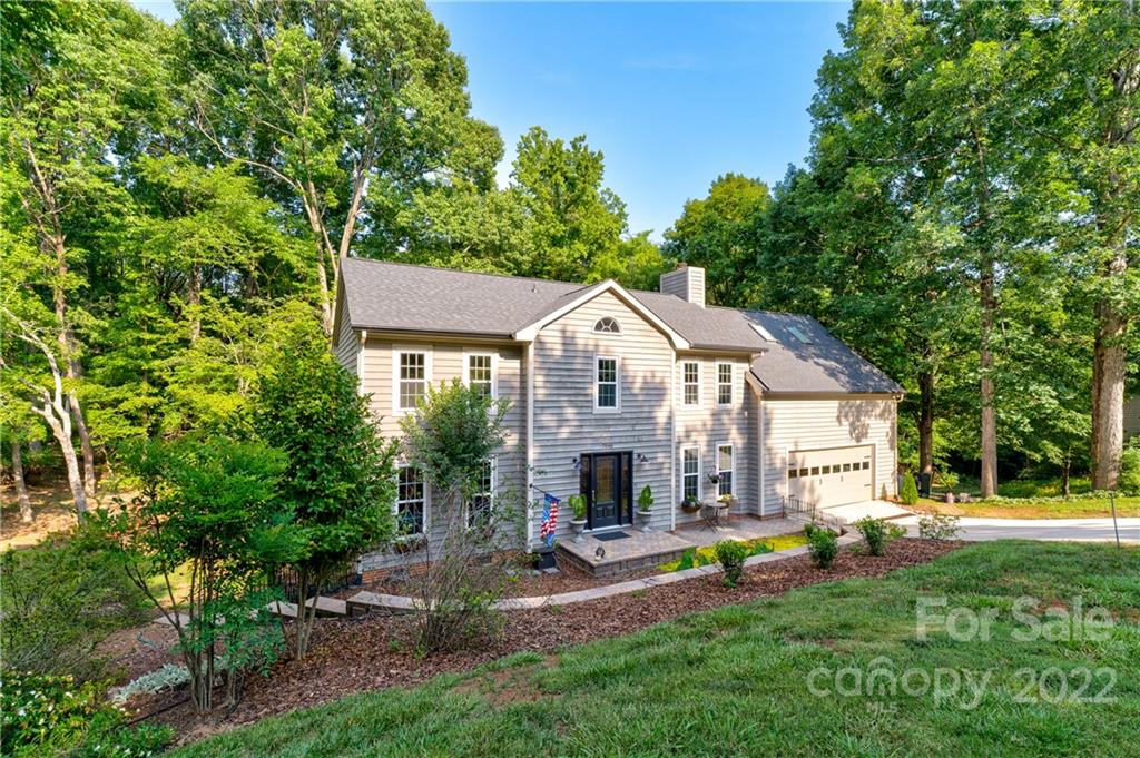 7046 Chelsea Day Lane Tega Cay, SC 29708 - Photo 3 of 36 a view of a house with backyard and sitting area
