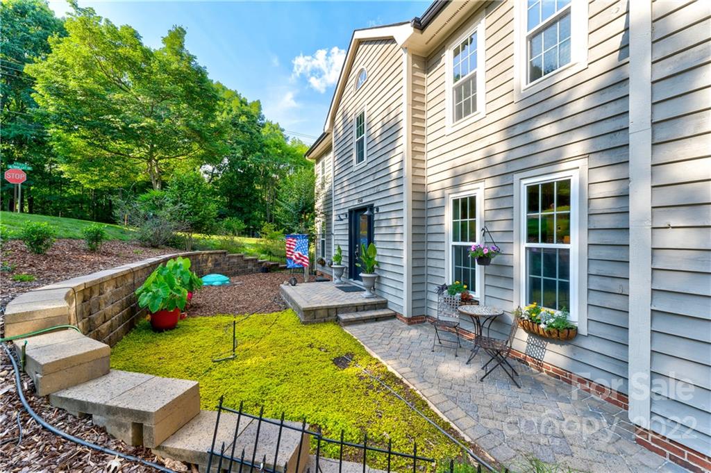7046 Chelsea Day Lane Tega Cay, SC 29708 - Photo 5 of 36 a view of a backyard with plants and a patio