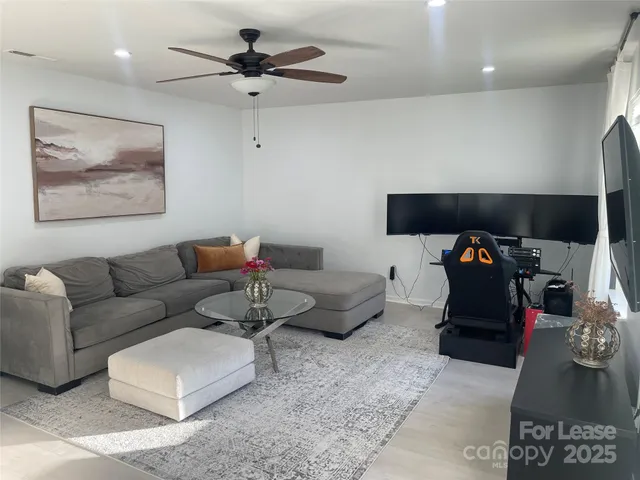 a living room with furniture and a gym