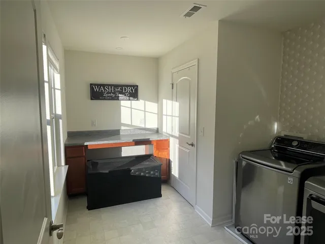 a kitchen with granite countertop a refrigerator and a stove top oven