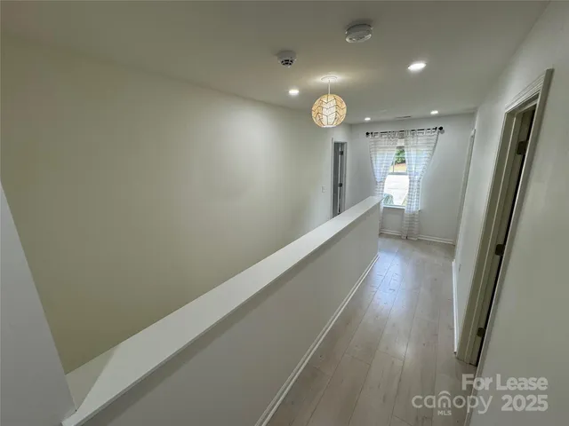 a view of hallway with wooden floor