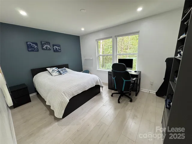 a bedroom with a bed a desk and chair