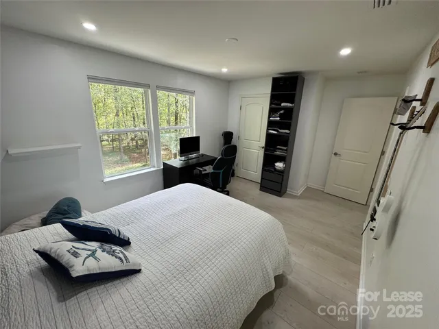 a bedroom with furniture and a window