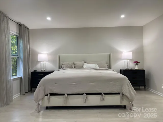 a bedroom with a bed and window