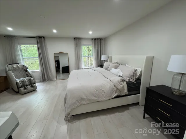 a spacious bedroom with a bed and a couch