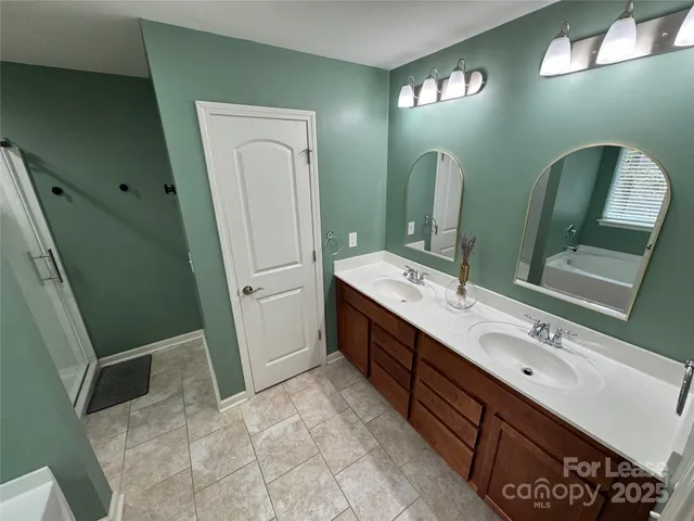 a bathroom with a double vanity sink and mirror