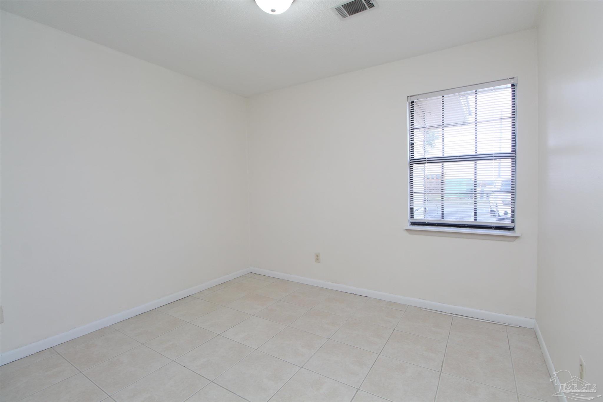 4964 West Spencer Field Road, Unit 6 Pace, FL 32571 - Photo 11 of 15 an empty room with a window