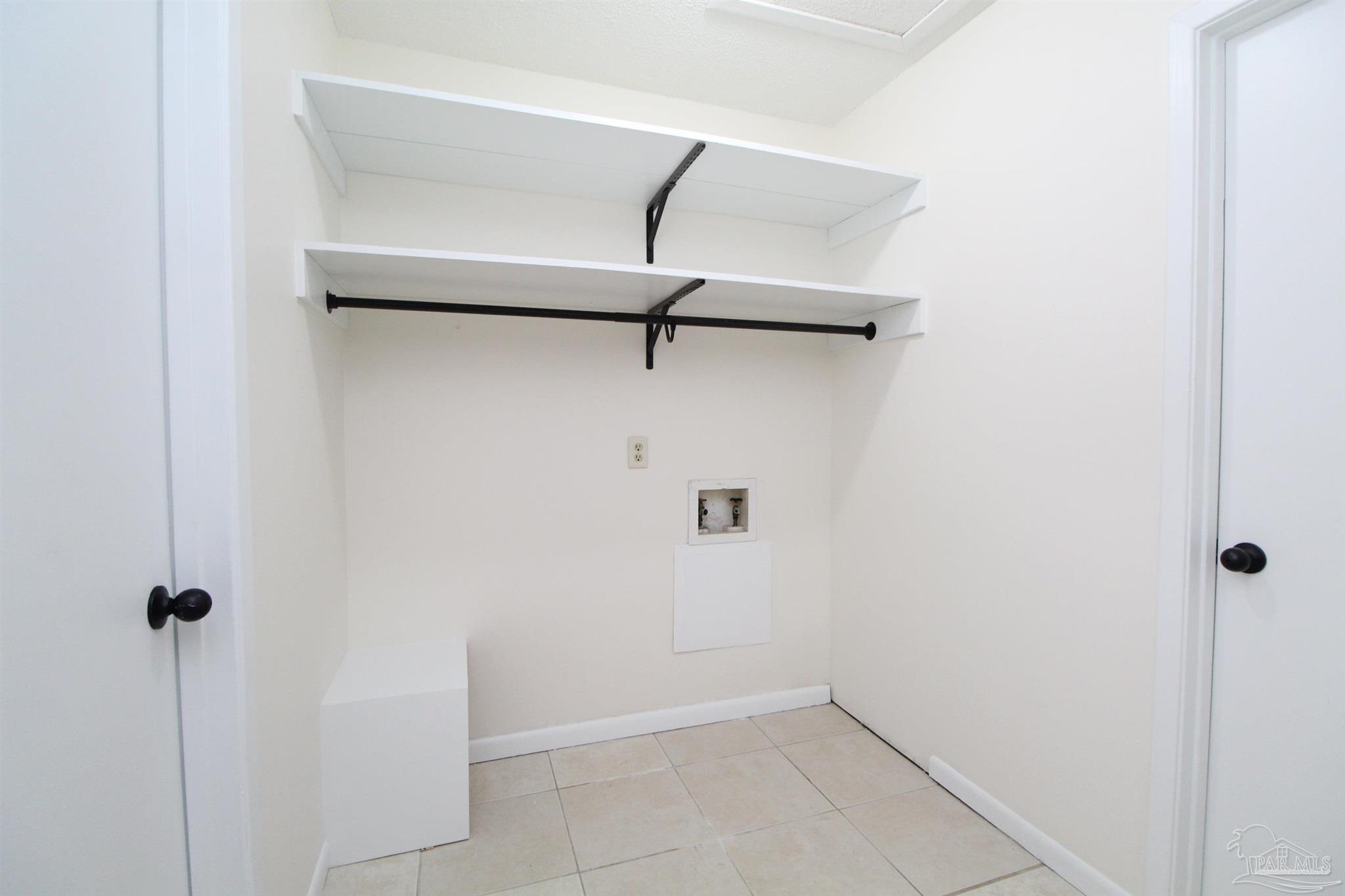 4964 West Spencer Field Road, Unit 6 Pace, FL 32571 - Photo 13 of 15 a view of a room with racks on the wall