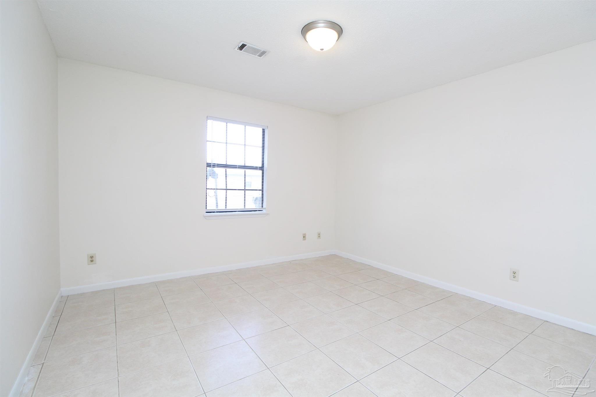 4964 West Spencer Field Road, Unit 6 Pace, FL 32571 - Photo 7 of 15 an empty room with windows