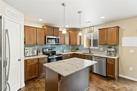 a kitchen with refrigerator and furniture