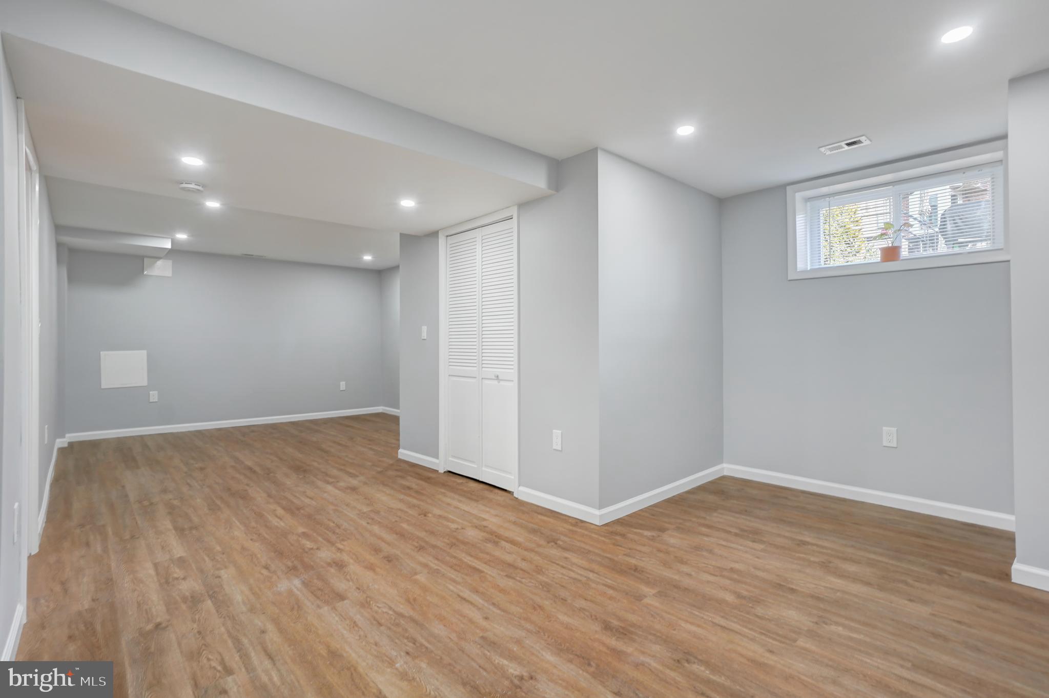1446 Roxanna Road Northwest Washington, DC 20012 - Photo 23 of 34 a view of an empty room with wooden floor and a window