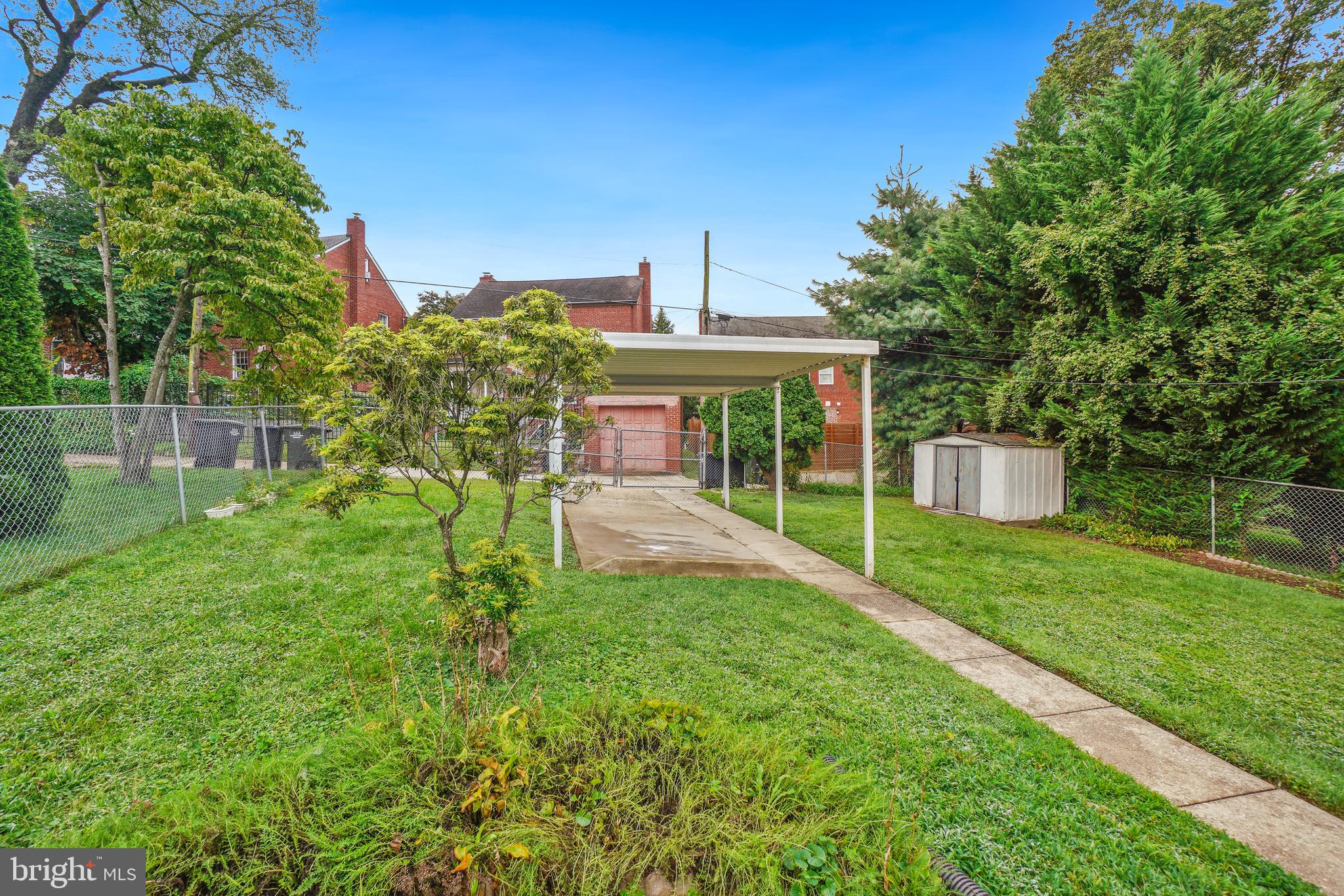 1446 Roxanna Road Northwest Washington, DC 20012 - Photo 32 of 34 a view of a house with backyard and a garden