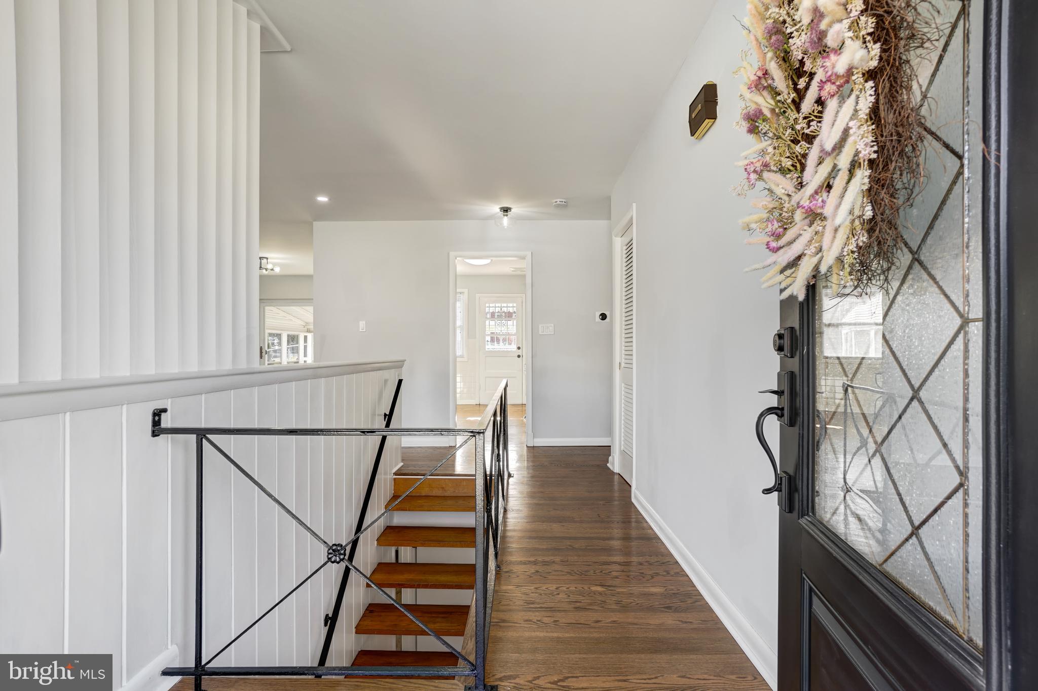 1446 Roxanna Road Northwest Washington, DC 20012 - Photo 4 of 34 a view of a hallway with wooden floor and staircase
