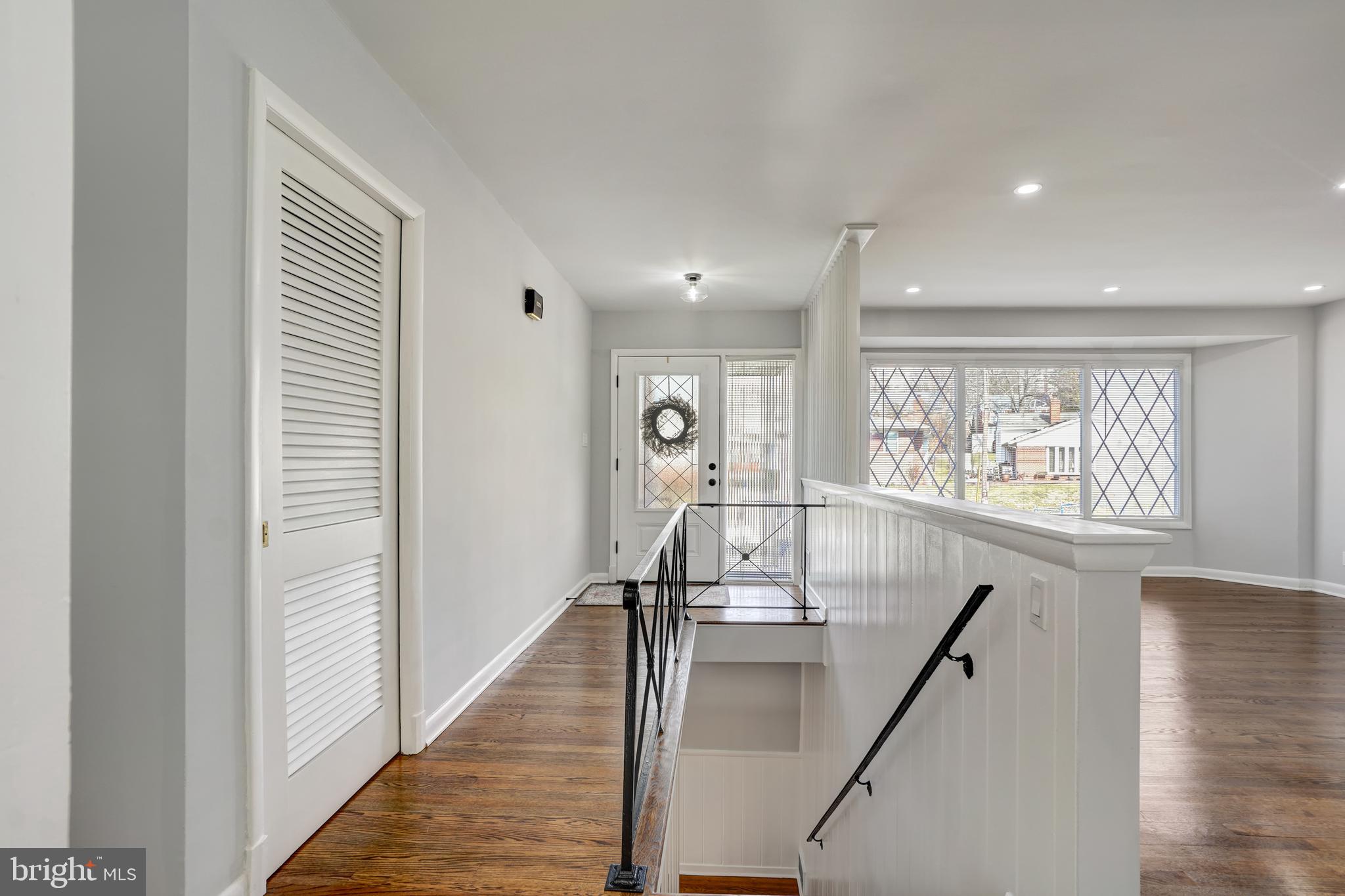1446 Roxanna Road Northwest Washington, DC 20012 - Photo 5 of 34 a view of a hallway with wooden floor and staircase