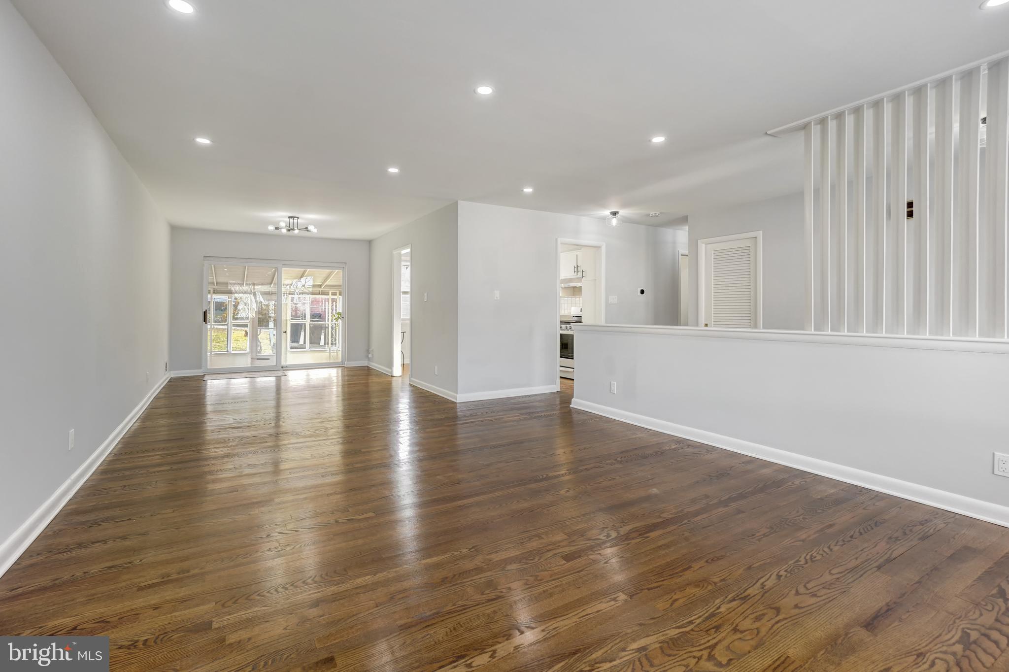 1446 Roxanna Road Northwest Washington, DC 20012 - Photo 6 of 34 an empty room with wooden floor and windows