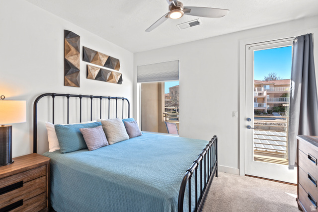 1122 South 1790th Street West, Unit 2 St. George, UT 84770 - Photo 22 of 37 Bedroom featuring a full-light glass panel door, light-colored carpeting, a ceiling fan with integrated lighting, and a window with a roller shade