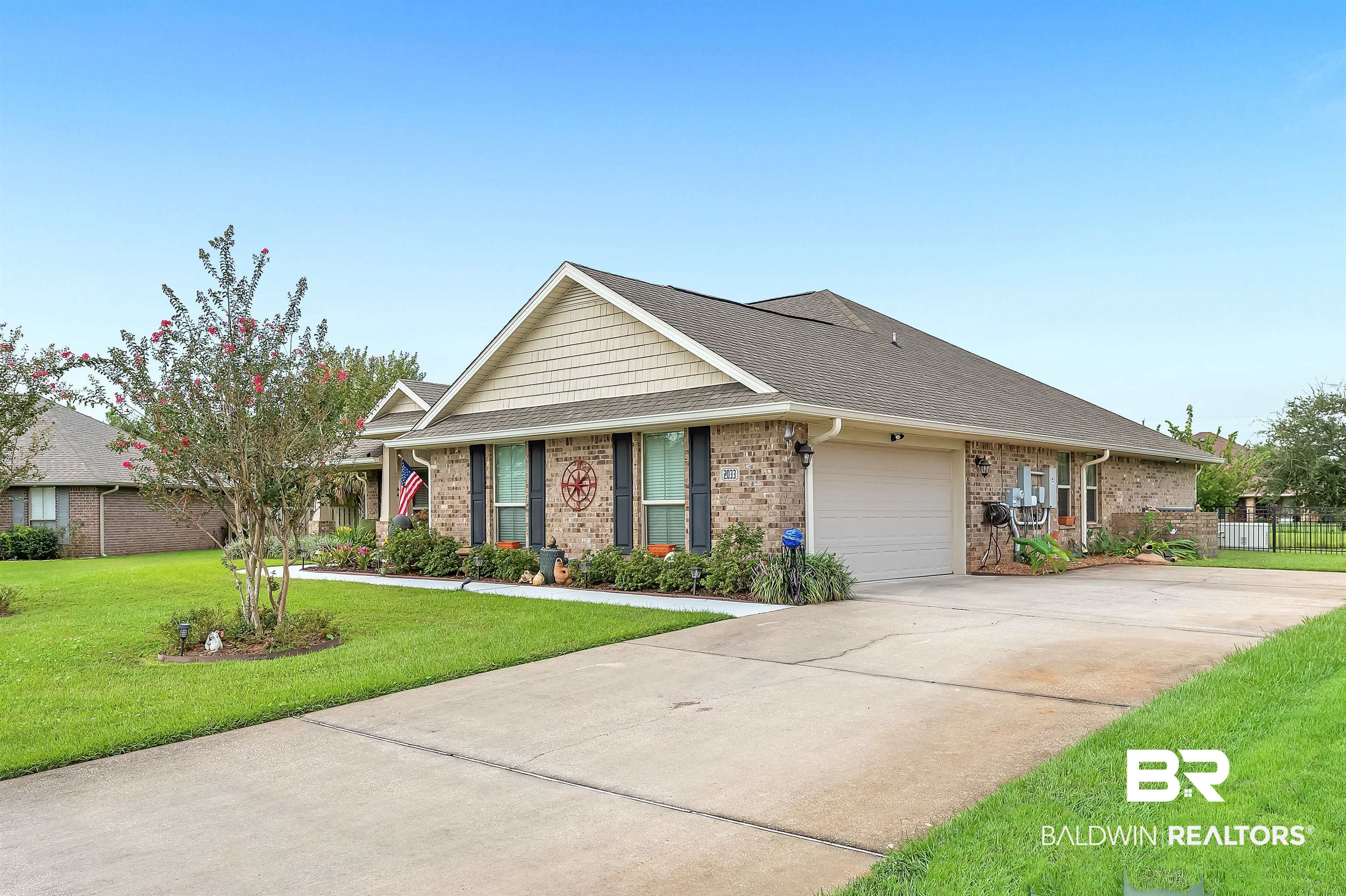 2033 Bourbon Street Foley, AL 36535 - Photo 9 of 57 View of front of house featuring a garage and a front lawn