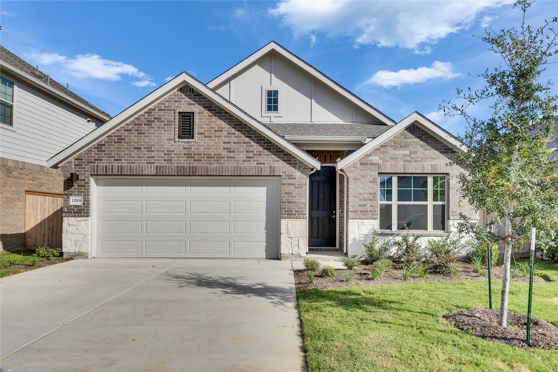 13709 Tucker Hedge Pass Elgin, TX 78621 - Photo 1 of 1 a front view of a house with a yard and garage