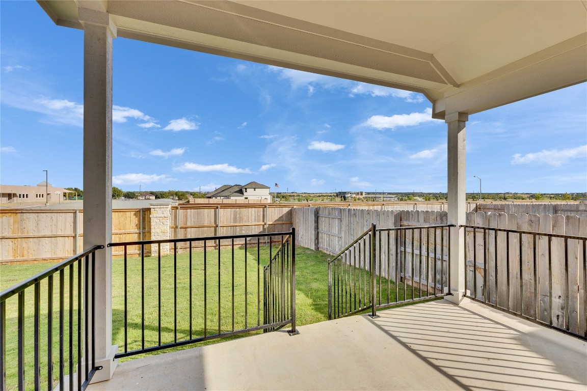 13709 Tucker Hedge Pass Elgin, TX 78621 - Photo 12 of 14 Fenced backyard featuring a patio and a residential view