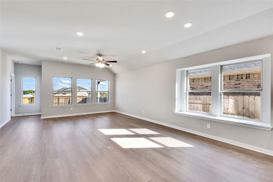 13709 Tucker Hedge Pass Elgin, TX 78621 - Photo 5 of 14 Spare room with recessed lighting, light wood-style flooring, a ceiling fan, and vaulted ceiling