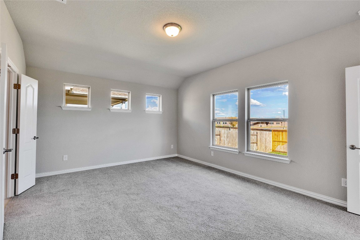 13709 Tucker Hedge Pass Elgin, TX 78621 - Photo 6 of 14 Unfurnished bedroom with light colored carpet and baseboards
