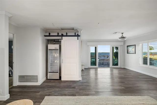 a kitchen with stainless steel appliances kitchen island granite countertop a table chairs sink and cabinets