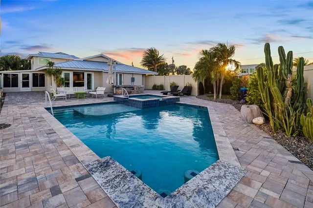 a view of a swimming pool with outdoor seating