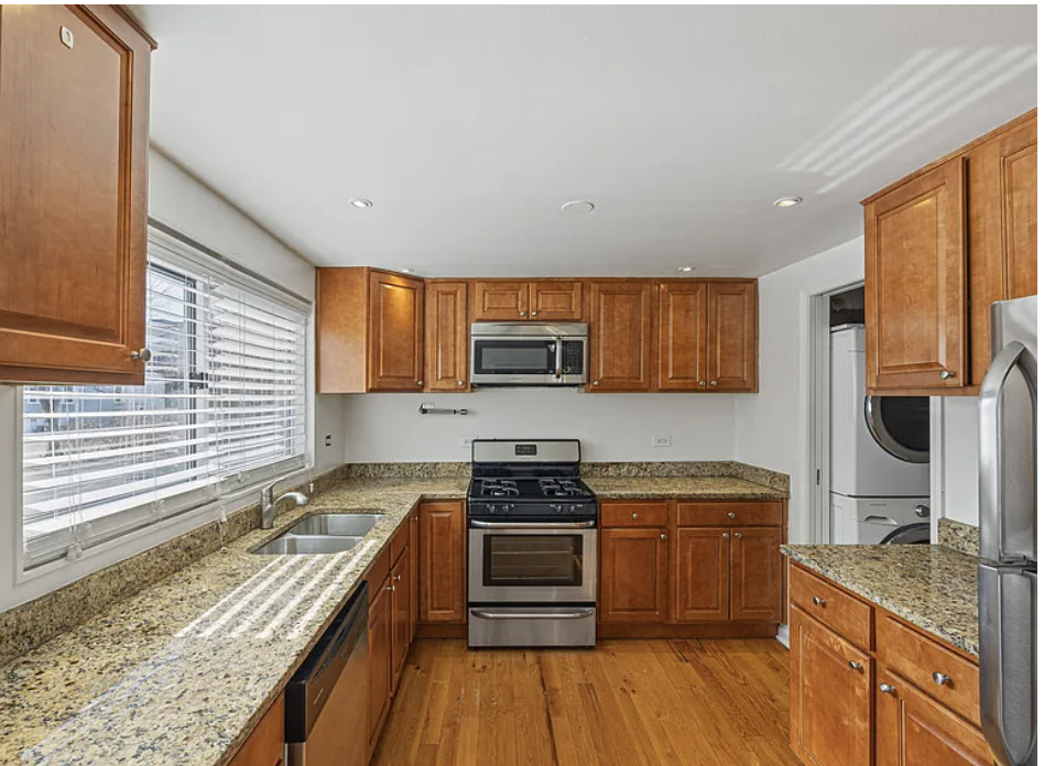 426 Ridge Road, Unit 426 Wilmette, IL 60091 - Photo 4 of 5 a kitchen with stainless steel appliances granite countertop a stove a sink and a refrigerator