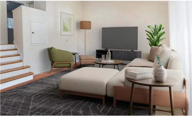 a living room with furniture and a potted plant